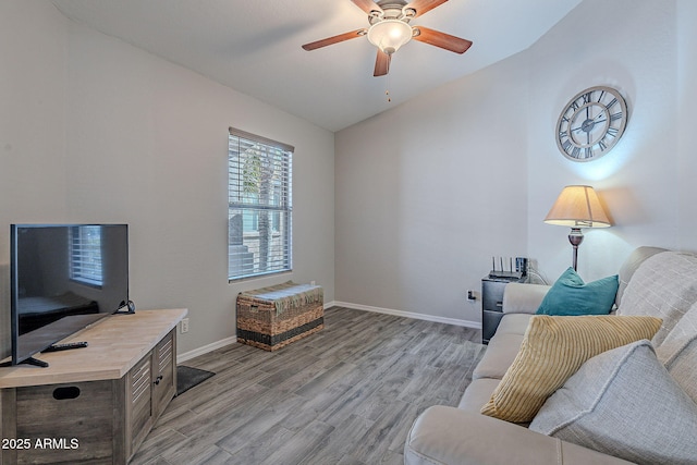 living room with vaulted ceiling, light hardwood / wood-style floors, and ceiling fan