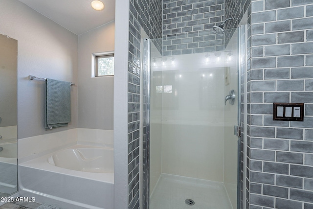 bathroom with separate shower and tub