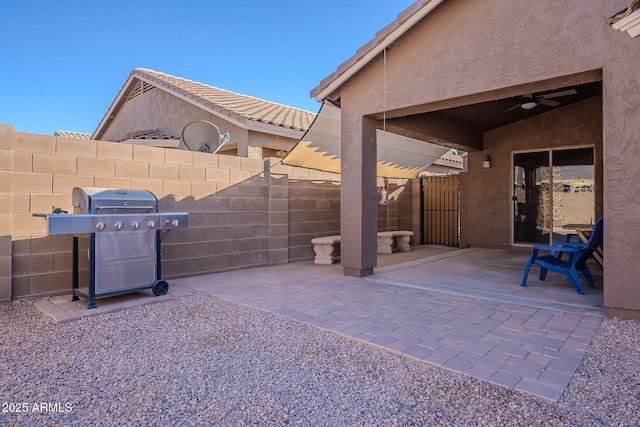 view of patio with area for grilling and ceiling fan