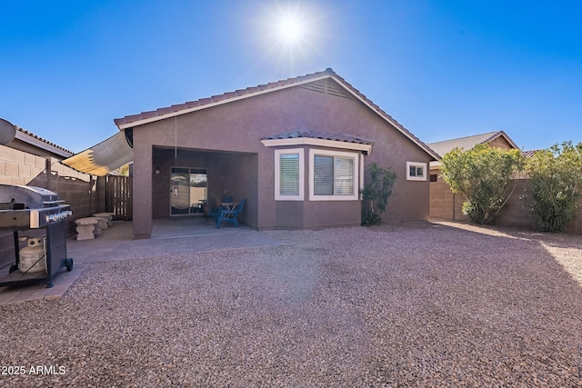 rear view of property featuring a patio