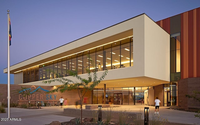 view of outdoor building at dusk