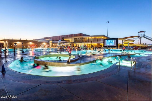 view of pool at dusk