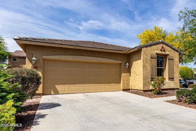 ranch-style home featuring an attached garage, stucco siding, and driveway
