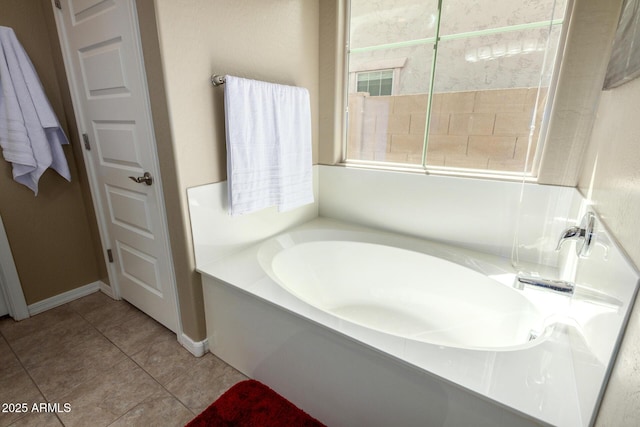 full bath with tile patterned floors, baseboards, and a bath