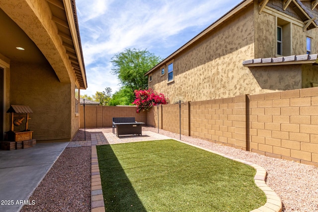 view of yard featuring a fenced backyard and a patio