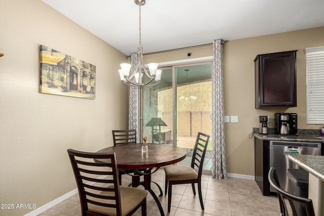 dining room featuring an inviting chandelier, light tile patterned floors, baseboards, and a healthy amount of sunlight