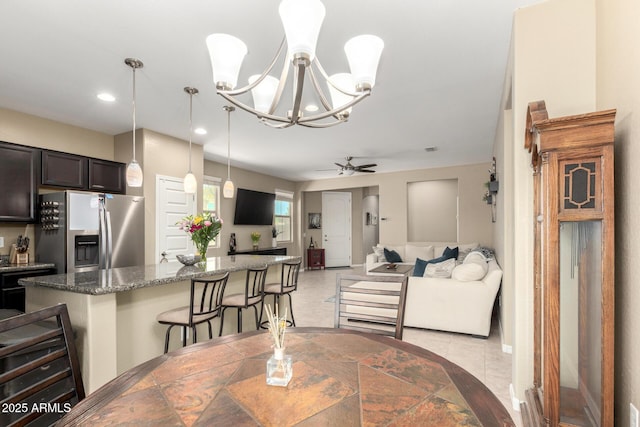 dining area with recessed lighting and ceiling fan with notable chandelier
