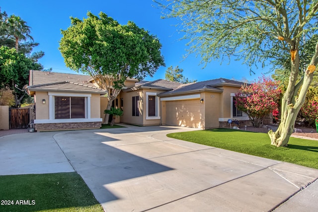 view of front of house featuring a garage and a front yard