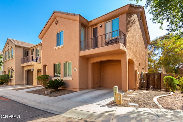 view of front of property featuring a garage and a balcony