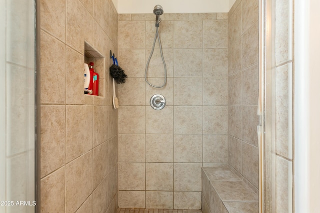 full bath featuring a tile shower