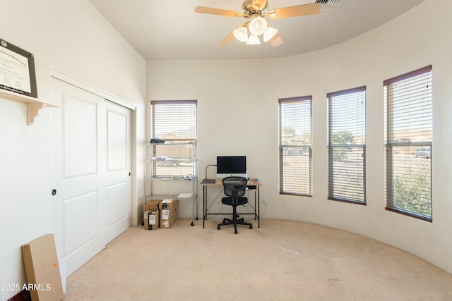 home office featuring light carpet, ceiling fan, and visible vents