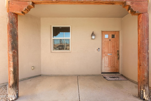 entrance to property with stucco siding