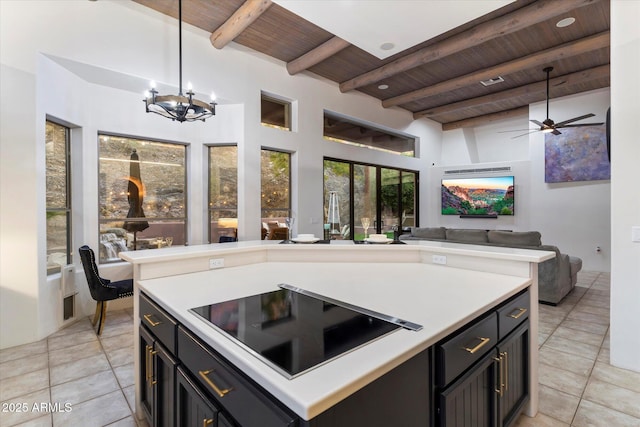 kitchen featuring decorative light fixtures, a center island, black electric stovetop, wooden ceiling, and beam ceiling