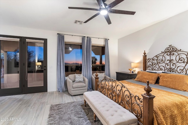 bedroom with hardwood / wood-style floors, access to outside, and ceiling fan