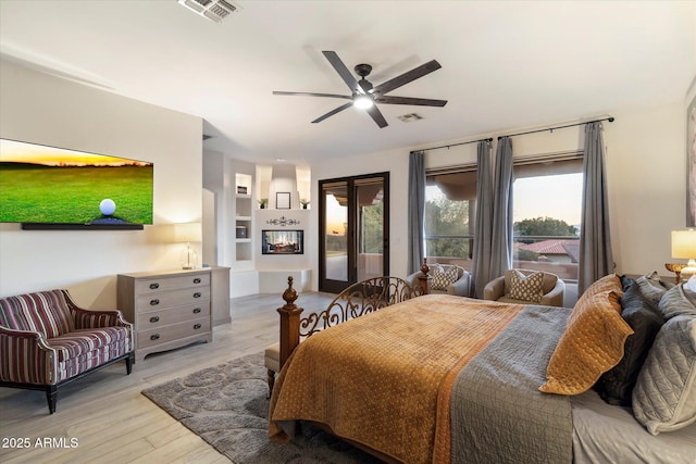 bedroom featuring ceiling fan, access to exterior, and light hardwood / wood-style floors