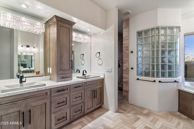 bathroom with vanity, a shower, and parquet floors