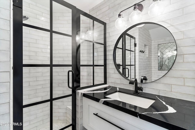 bathroom featuring vanity and a tile shower