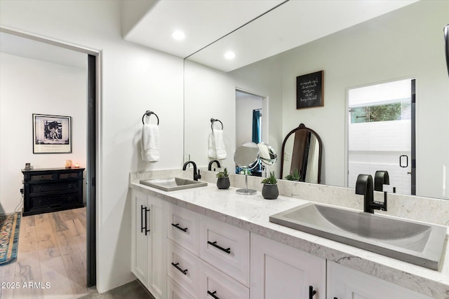 bathroom with vanity and hardwood / wood-style flooring