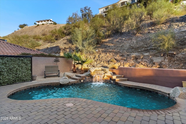 view of pool with pool water feature