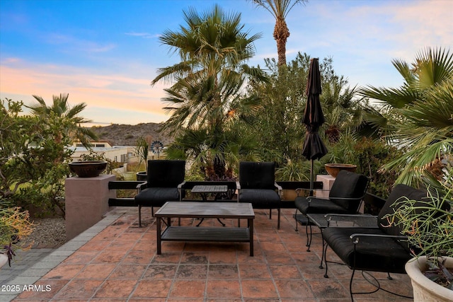 patio terrace at dusk with an outdoor living space