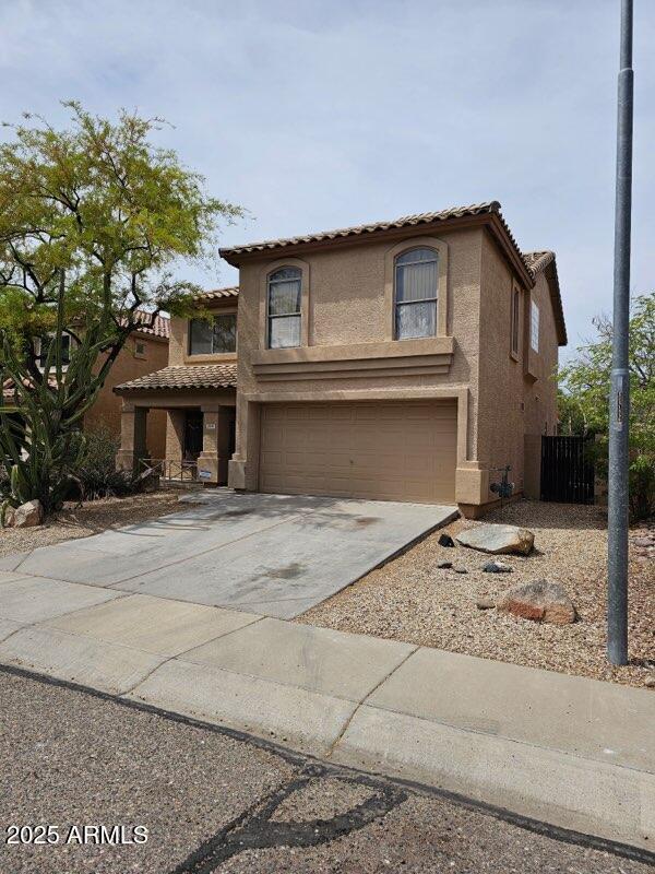 2514 W Big Oak St, Phoenix, AZ 85085 - view of front facade with an attached garage, driveway, a tile roof, and stucco siding