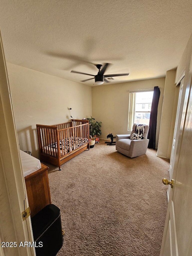 2514 W Big Oak St, Phoenix, AZ 85085 - bedroom featuring carpet floors, a textured ceiling, a crib, and ceiling fan