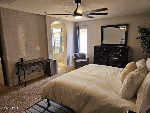 2514 W Big Oak St, Phoenix, AZ 85085 - carpeted bedroom featuring a ceiling fan, a textured ceiling, arched walkways, baseboards, and ensuite bath