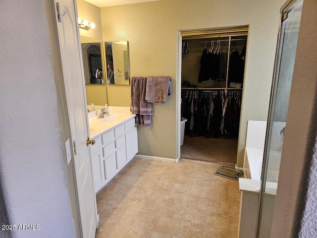 2514 W Big Oak St, Phoenix, AZ 85085 - bathroom featuring a walk in closet, a washtub, a shower stall, vanity, and a textured wall