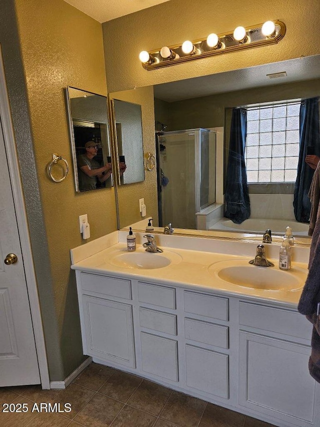 2514 W Big Oak St, Phoenix, AZ 85085 - bathroom with a sink, tile patterned flooring, a stall shower, and a textured wall