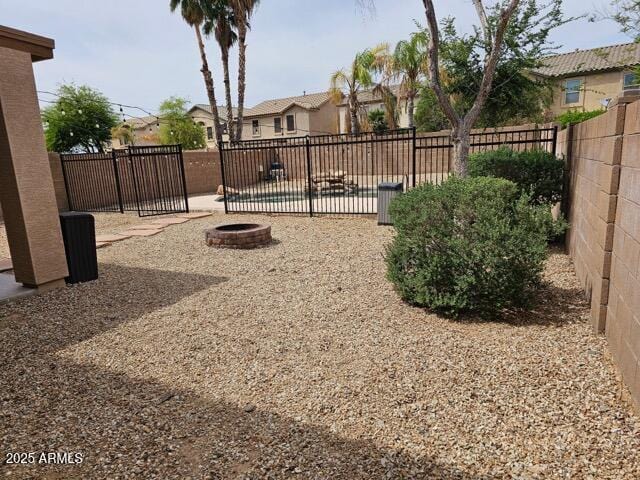 2514 W Big Oak St, Phoenix, AZ 85085 - view of yard featuring a fenced backyard, an outdoor fire pit, and a residential view