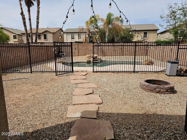 2514 W Big Oak St, Phoenix, AZ 85085 - view of yard featuring a fenced backyard, a fenced in pool, a patio area, an outdoor fire pit, and a residential view