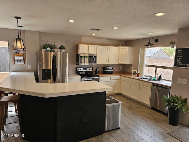 2514 W Big Oak St, Phoenix, AZ 85085 - kitchen with appliances with stainless steel finishes, a sink, light countertops, light wood-type flooring, and visible vents