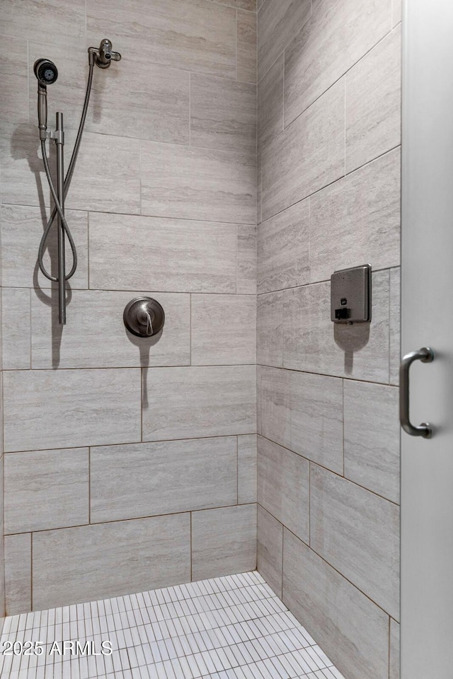 full bath with a tile shower