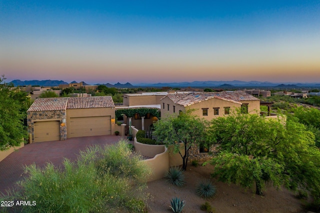 40039 N 107th Pl, Scottsdale, AZ 85262 - view of front facade with stucco siding, an attached garage, decorative driveway, a tile roof, and stone siding