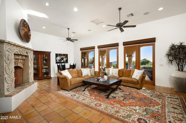 40039 N 107th Pl, Scottsdale, AZ 85262 - living area with ceiling fan, tile patterned floors, a fireplace, recessed lighting, and a towering ceiling