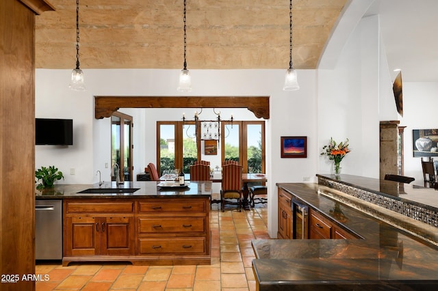 40039 N 107th Pl, Scottsdale, AZ 85262 - kitchen featuring a sink, stainless steel dishwasher, brown cabinetry, beverage cooler, and pendant lighting