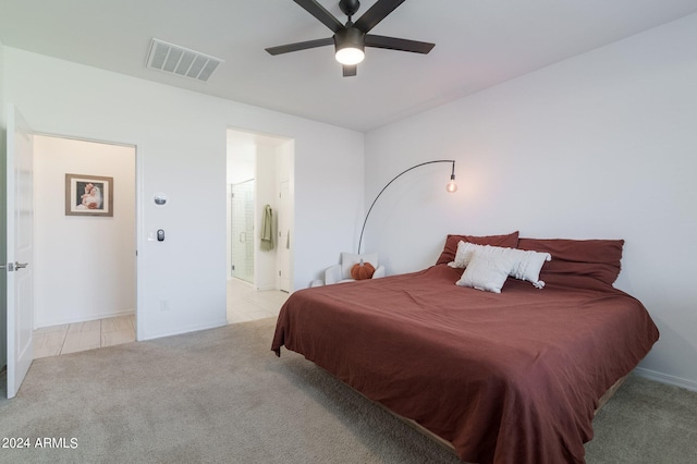 carpeted bedroom featuring connected bathroom and ceiling fan