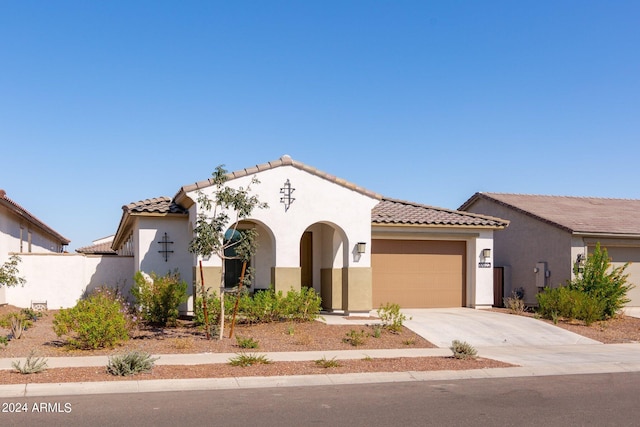 mediterranean / spanish-style home with a garage