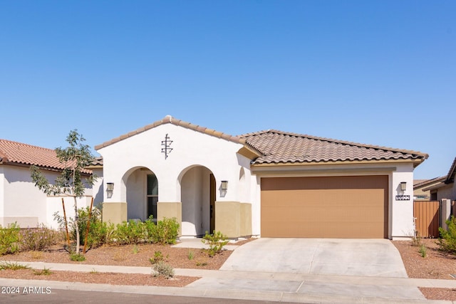 mediterranean / spanish-style house with a garage