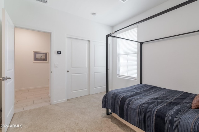 carpeted bedroom featuring a closet