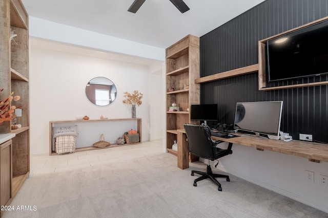 carpeted home office featuring ceiling fan