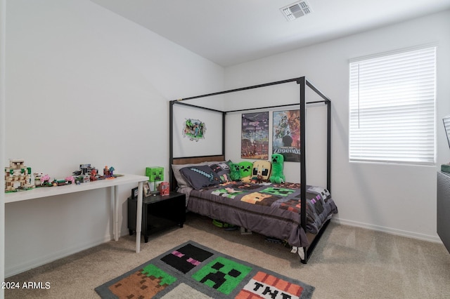 carpeted bedroom featuring multiple windows