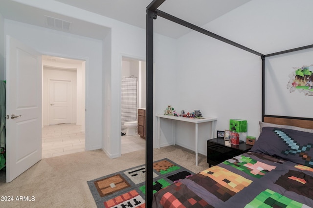 carpeted bedroom with connected bathroom