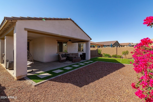 back of property featuring a patio and ceiling fan