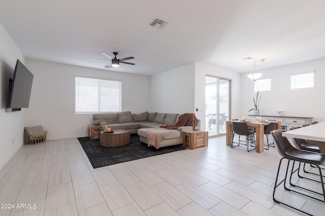 living room featuring a healthy amount of sunlight and ceiling fan