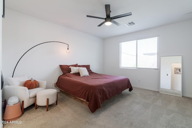 bedroom with light carpet and ceiling fan