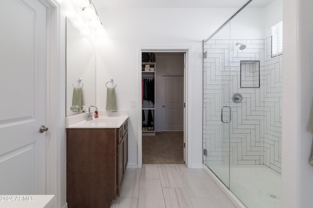 bathroom featuring vanity and an enclosed shower