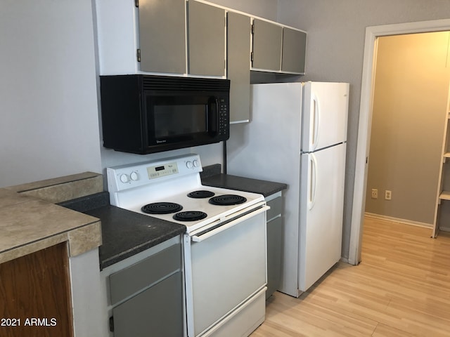 4042 E Carson Rd, Phoenix, AZ 85042 - kitchen with white appliances, gray cabinetry, light wood finished floors, and dark countertops