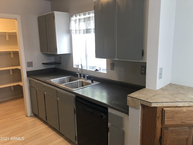 4042 E Carson Rd, Phoenix, AZ 85042 - kitchen featuring dishwasher, light wood finished floors, and dark countertops