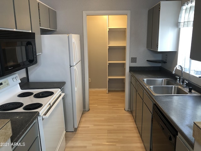 4042 E Carson Rd, Phoenix, AZ 85042 - kitchen with black appliances, light wood-style flooring, dark countertops, and gray cabinets